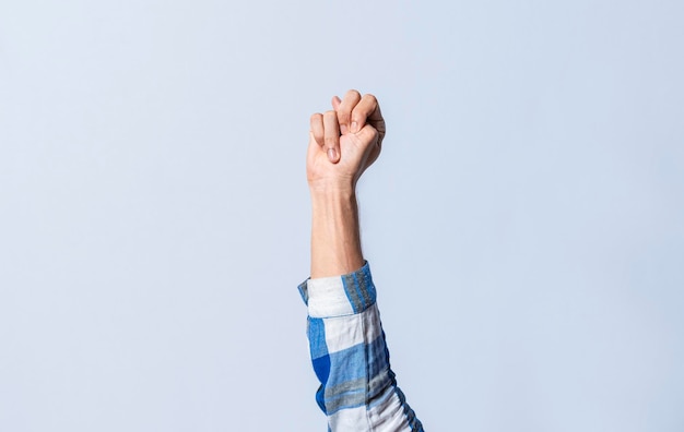 Hand gesturing the letter n in sign language on an isolated\
background man\'s hand gesturing the letter n of the alphabet\
isolated letter n of the alphabet in sign language