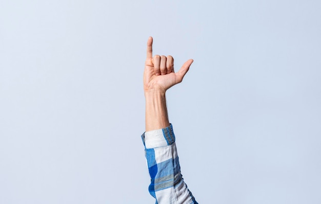 Hand gesturing the letter y in sign language on an isolated\
background man\'s hand gesturing the letter y of the alphabet\
isolated letter y of the alphabet in sign language