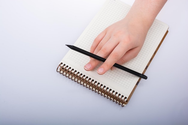 Hand of girl holding pen with writing on paper Business and education concept