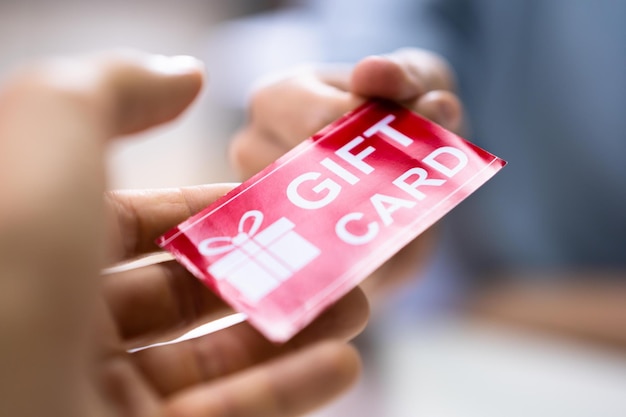 hand giving gift voucher card