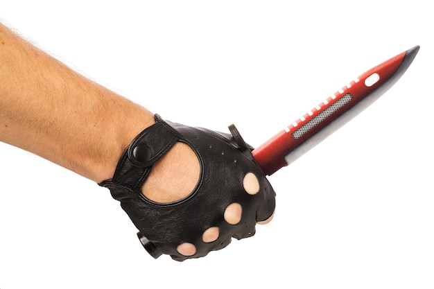 Hand in a glove with a toy wooden knife isolated on a white background