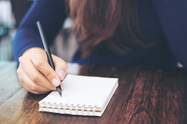 hand going to write down on blank notebook