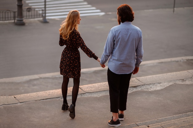 Mano nella mano una coppia. passeggiata nella città serale. estate