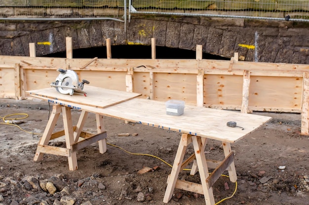 Photo hand held circular saw on workbench