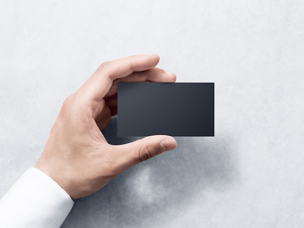 Hand hold blank plain black business card design 