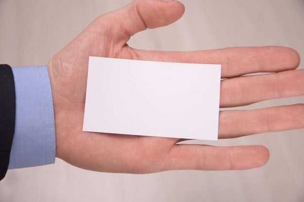 Hand hold blank white card mockup with rounded corners. Plain call-card mock up template holding arm. Plastic credit namecard display front. Check offset card design. Business branding.