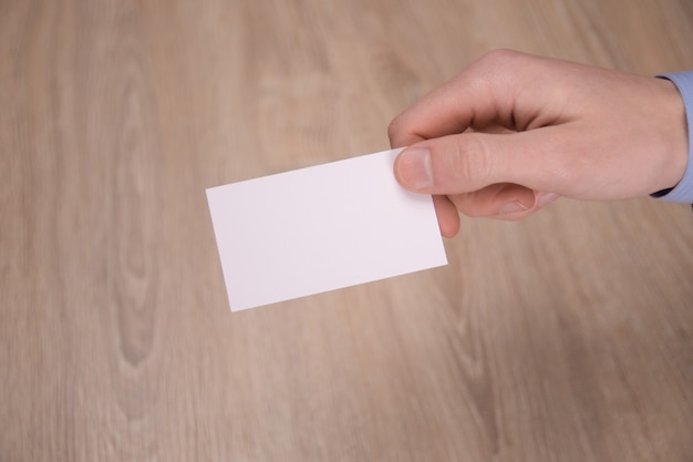 Hand hold blank white card mockup with rounded corners. Plain call-card mock up template holding arm. Plastic credit namecard display front. Check offset card design. Business branding.