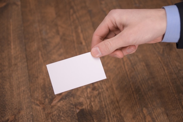 Hand hold blank white card mockup with rounded corners