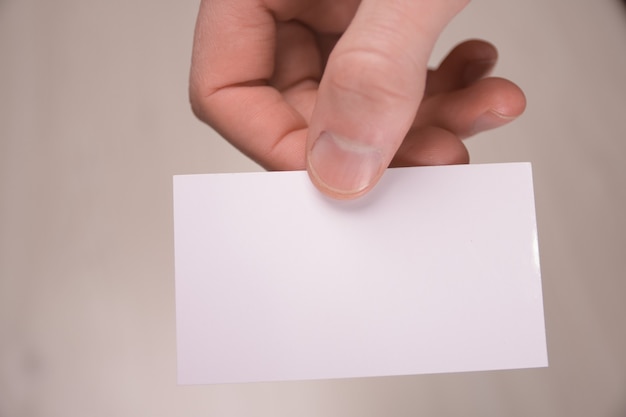 Hand hold blank white card mockup with rounded corners