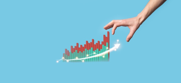 Photo hand hold drawing on screen growing graph, arrow of positive growth icon.pointing at creative business chart with upward arrows.financial, business growth concept.