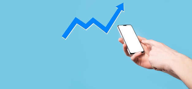 Hand hold drawing on screen growing graph, arrow of positive growth icon.pointing at creative business chart with upward arrows.Financial, business growth concept.