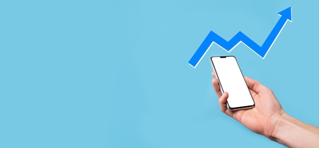 Hand hold drawing on screen growing graph, arrow of positive growth icon.pointing at creative business chart with upward arrows.Financial, business growth concept.