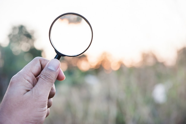 Hand hold of magnifying glass searching