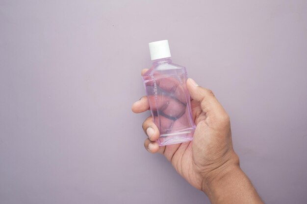 Hand hold a mouthwash liquid container