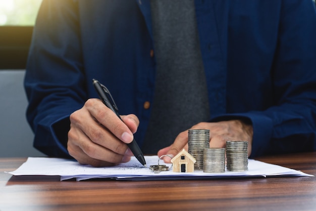 Hand hold pen writing on document home loan