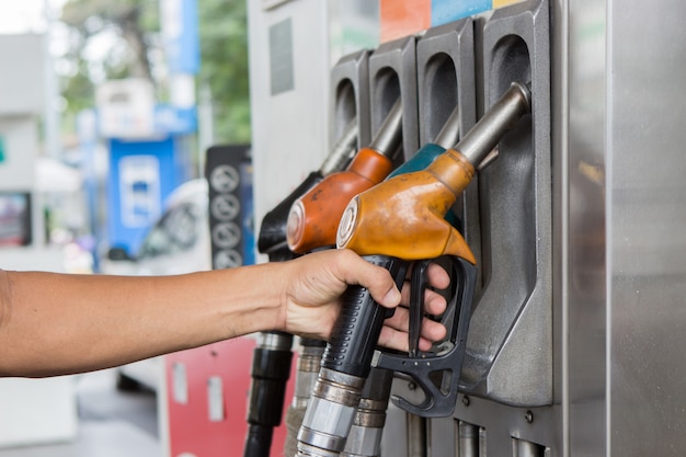 Hand hold petroleum gasoline on station