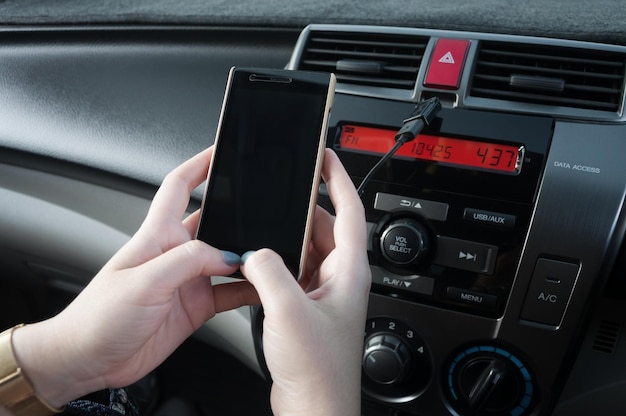 Hand hold smartphone in carPeople press the phone while driving