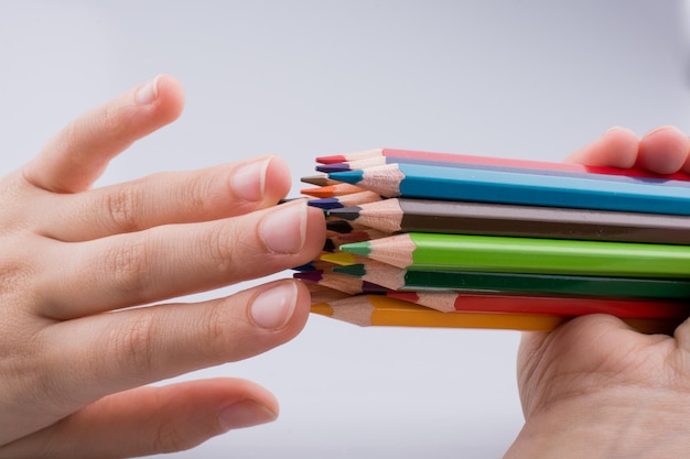 Hand holdin pencils