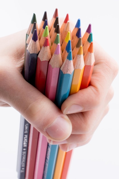 Hand holdin pencils