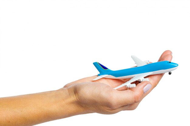 Hand holding airplane toy model isolated on white background