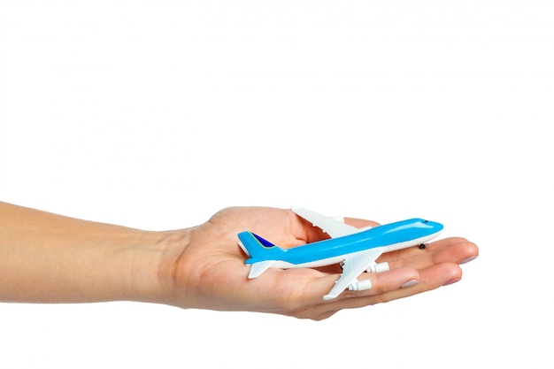 Hand holding airplane toy model isolated