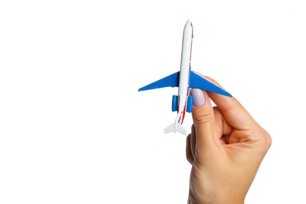 Hand holding airplane toy model 