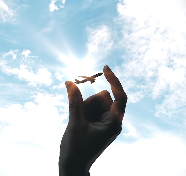 Hand holding airplane