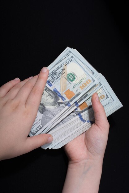 Hand holding American dollar banknotes isolated on white background