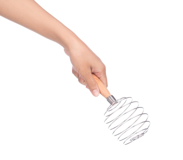 hand holding Balloon whisk manual hand egg beater isolated on a white background