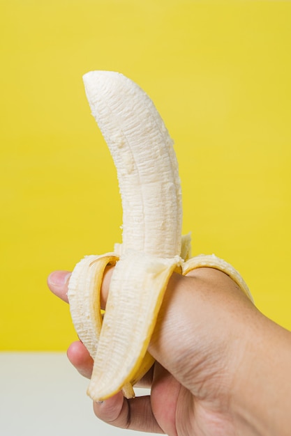 Concetto di nutrizione della frutta della banana della tenuta della mano