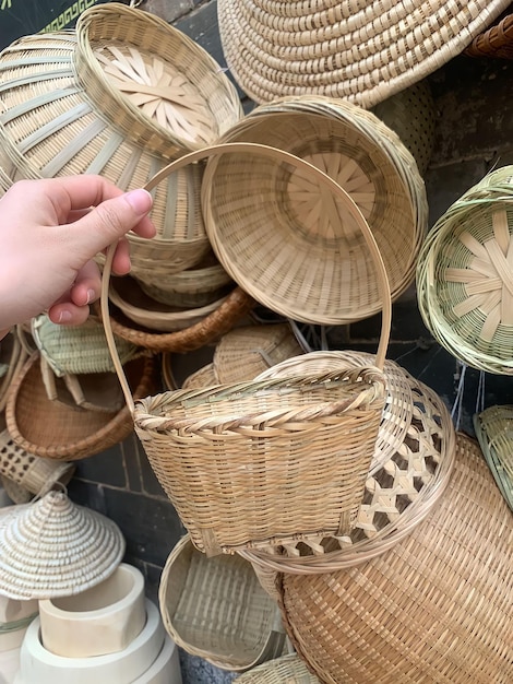 A hand holding a basket that says'bamboo'on it