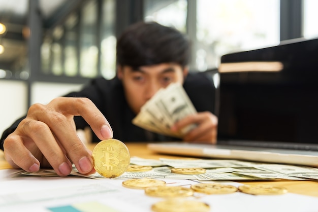 Hand holding bitcoin,One business man with one bitcoin crypto currency in his hand.New Virtual money