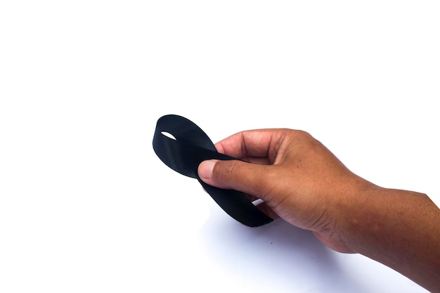 A hand holding a black circle with the word black on it.