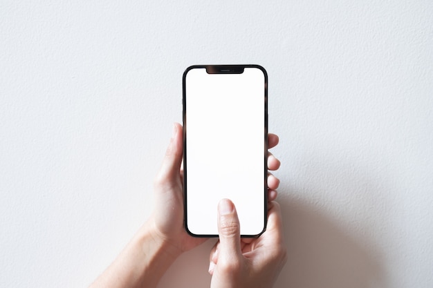 Hand holding black smartphone with white screen