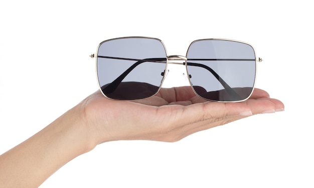 Hand holding Black sunglasses isolated on white background