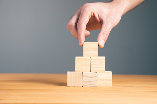 Hand holding blank wooden block cubes, business concept