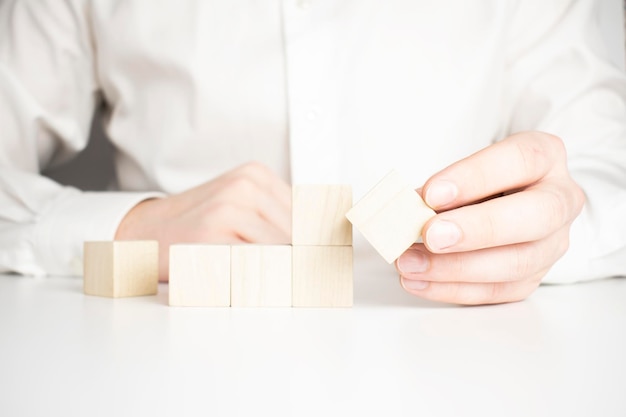 Hand holding blank wooden block cubes on table background business concept background mock up template banner