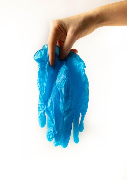 Hand holding blue medical gloves.