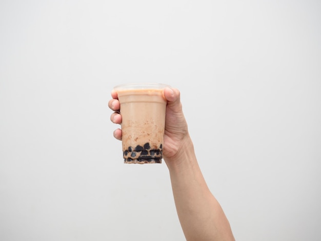 Hand holding boba tea isolated