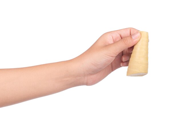 hand holding boiled bamboo shoots isolated on white background