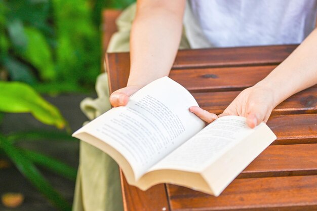 Hand holding book in the park garden Mindfulness living