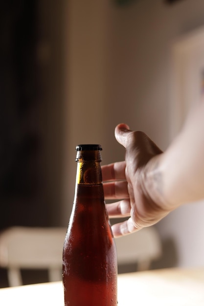 Hand holding a bottle of beer