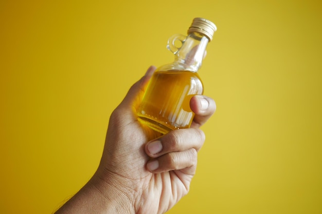 Hand holding a bottle of olive oil