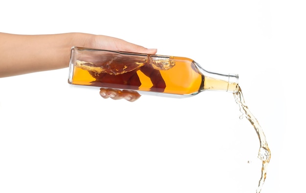 hand holding bottle pouring wine isolated on white background