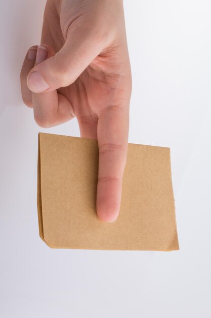 Hand holding a brown color paper