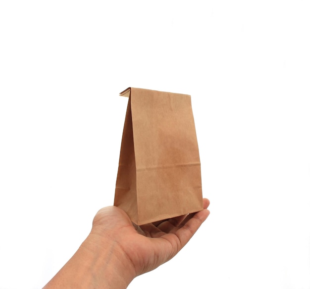 Hand holding a brown paper bag