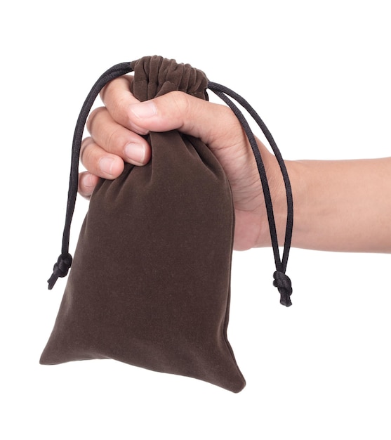 Hand holding Brown velvet bag isolated on white background