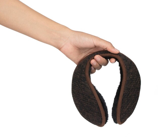 Hand holding A Brown winter knitted earmuffs isolated on white background.