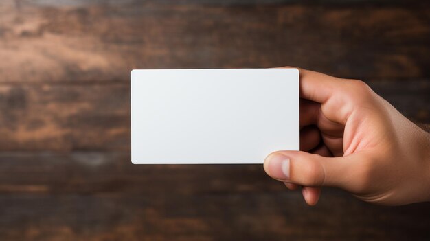 A hand holding a business card