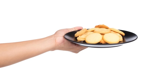 hand holding butter cookies on a dish isolated on white background